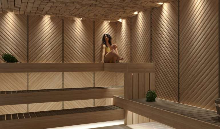 a woman sitting in a sauna in a wooden sauna