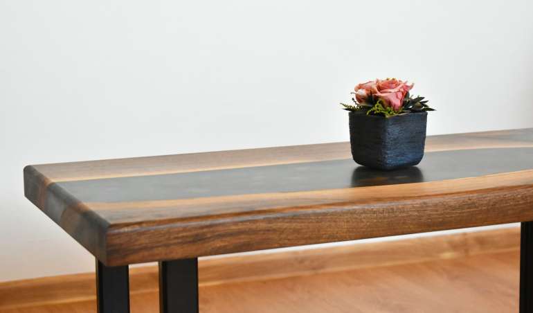 red flower on blue ceramic vase on brown wooden table