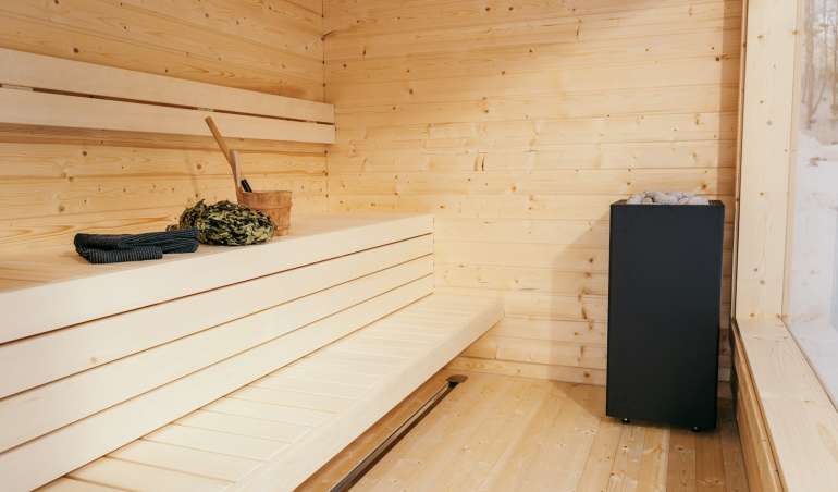 a room with a wood floor and a wood wall with a black box