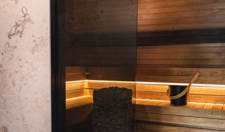 a sauna room with a sauna in the middle of it