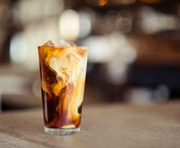 glass cup filled with ice latte on tabletop