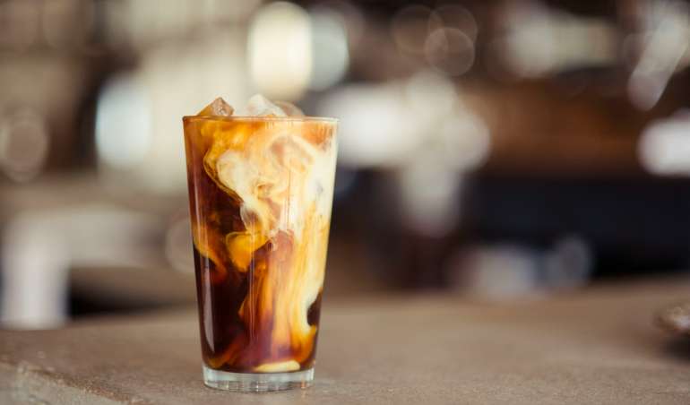 glass cup filled with ice latte on tabletop