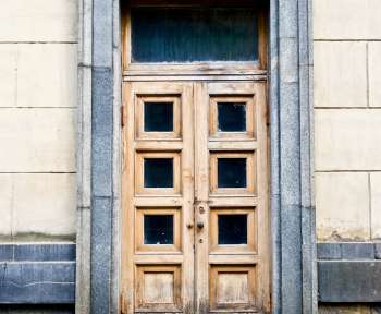 white concrete building showing closed door