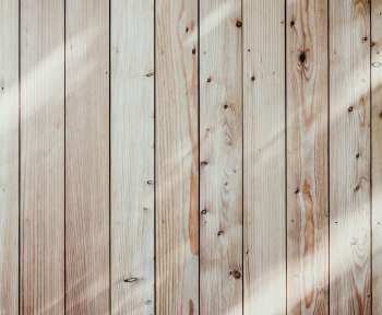 a close up of a wooden wall with a light shining on it