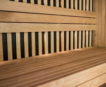 a close up of a wooden bench with horizontal slats