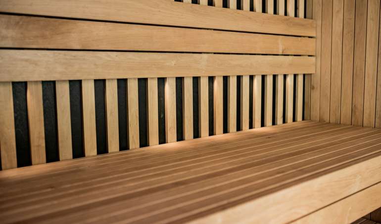 a close up of a wooden bench with horizontal slats