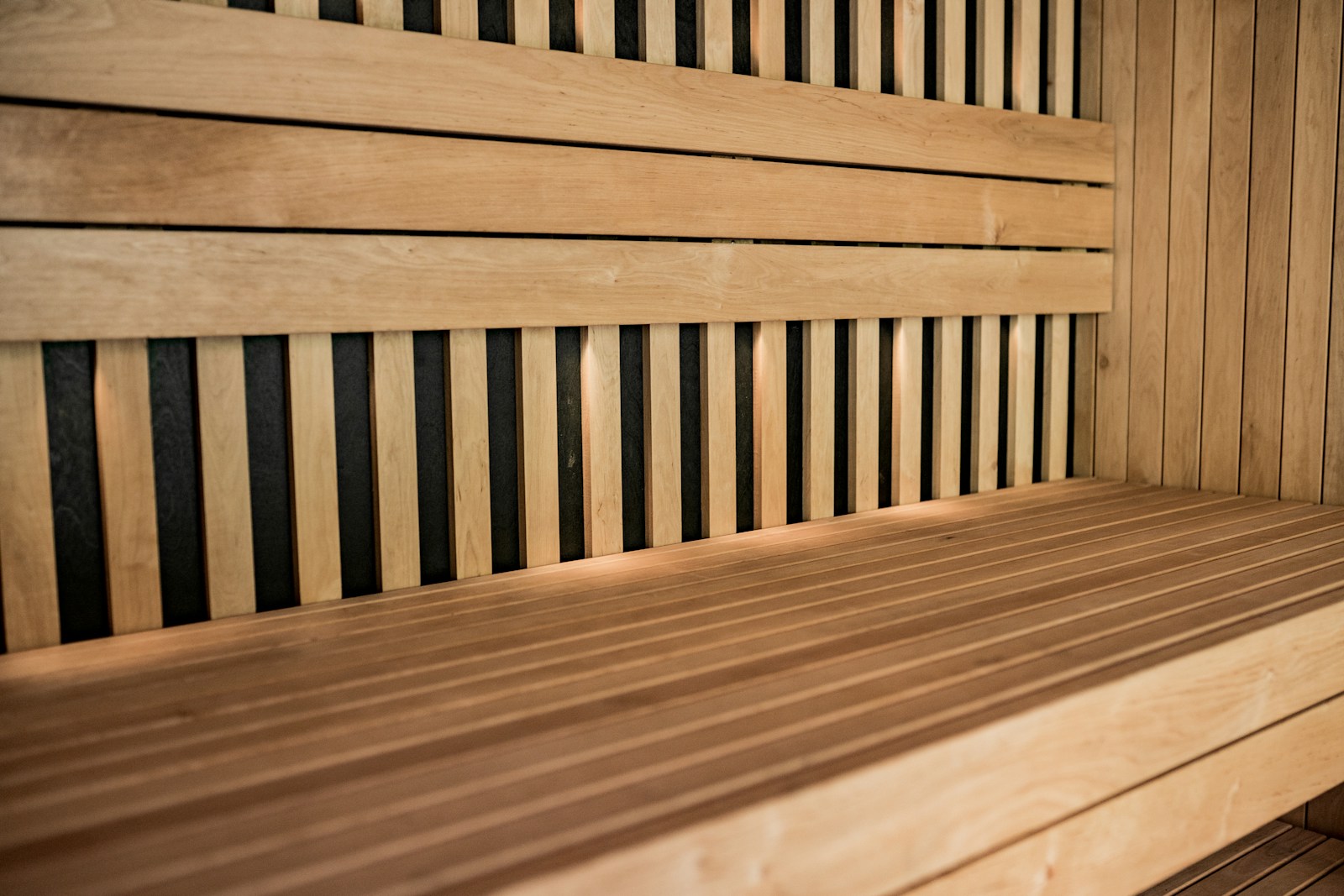 a close up of a wooden bench with horizontal slats